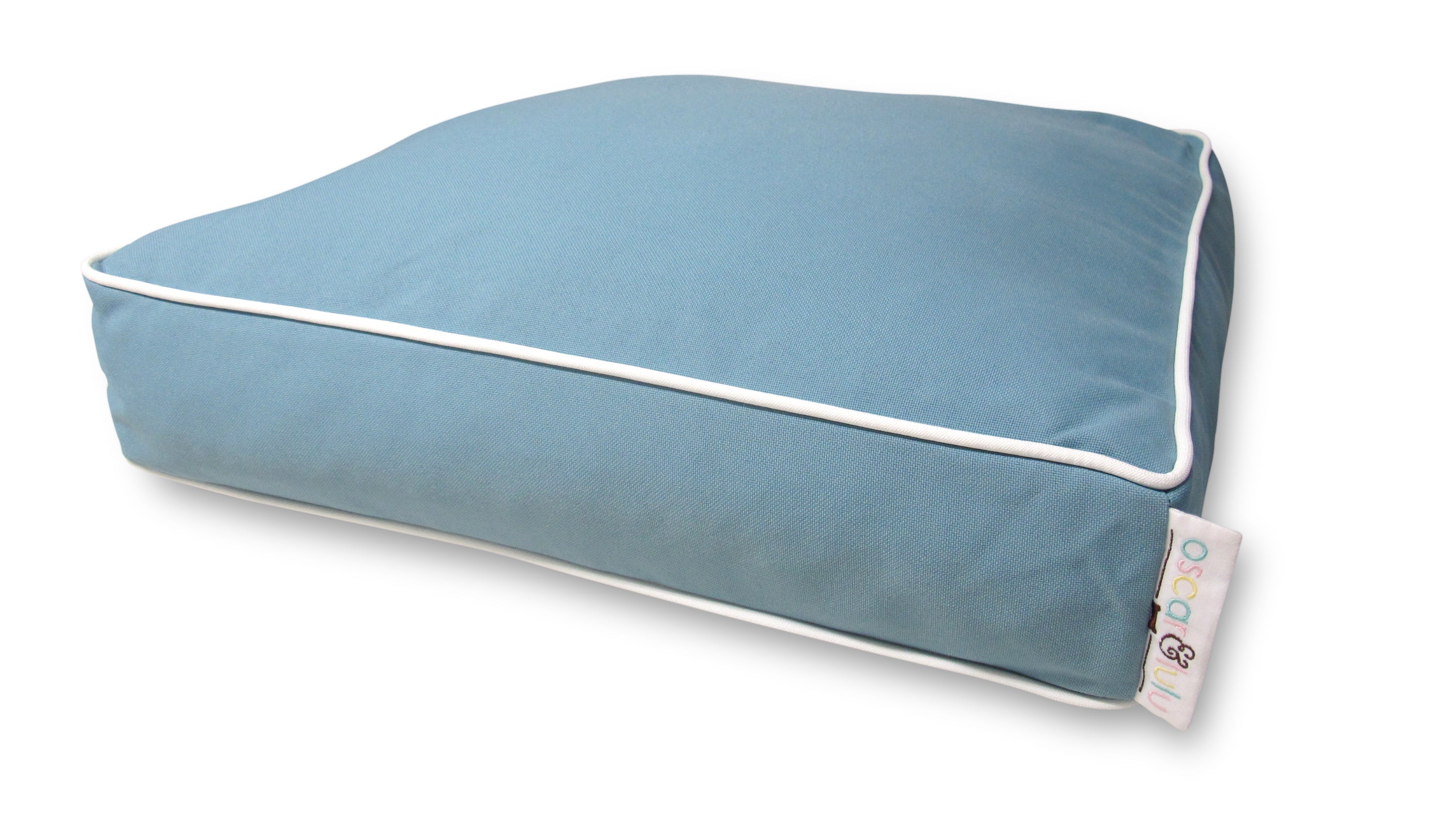 Light blue indoor outdoor fabric with white piping dog bed